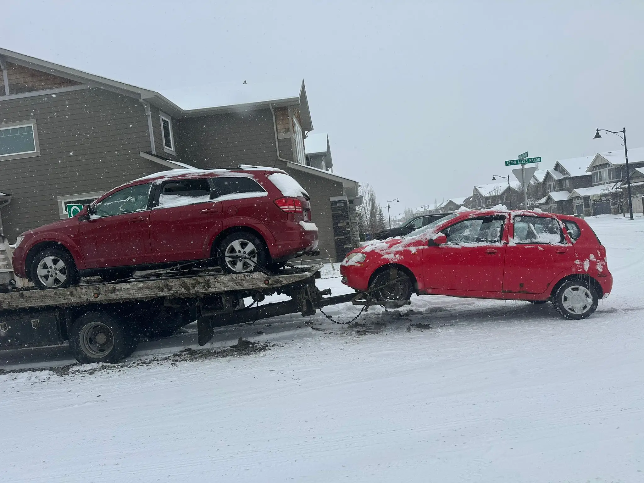 Two cars on flatbed snowy day