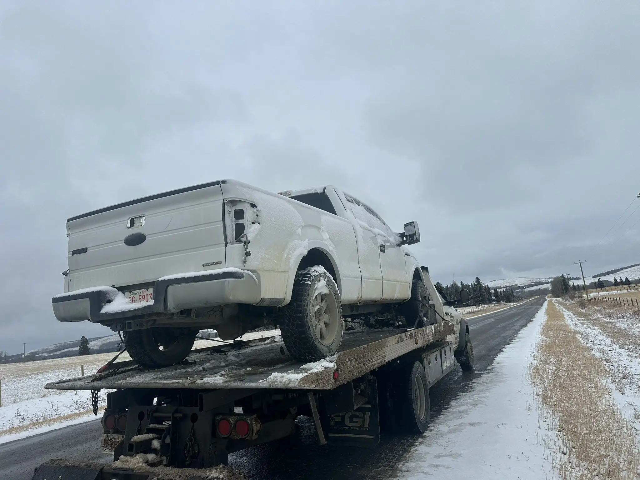 White truck towed in winter Calgary
